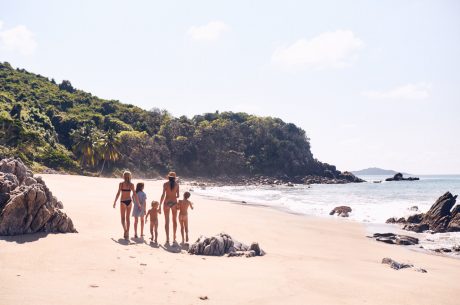 Abigail and her children on the beach near their home in Costa Rica